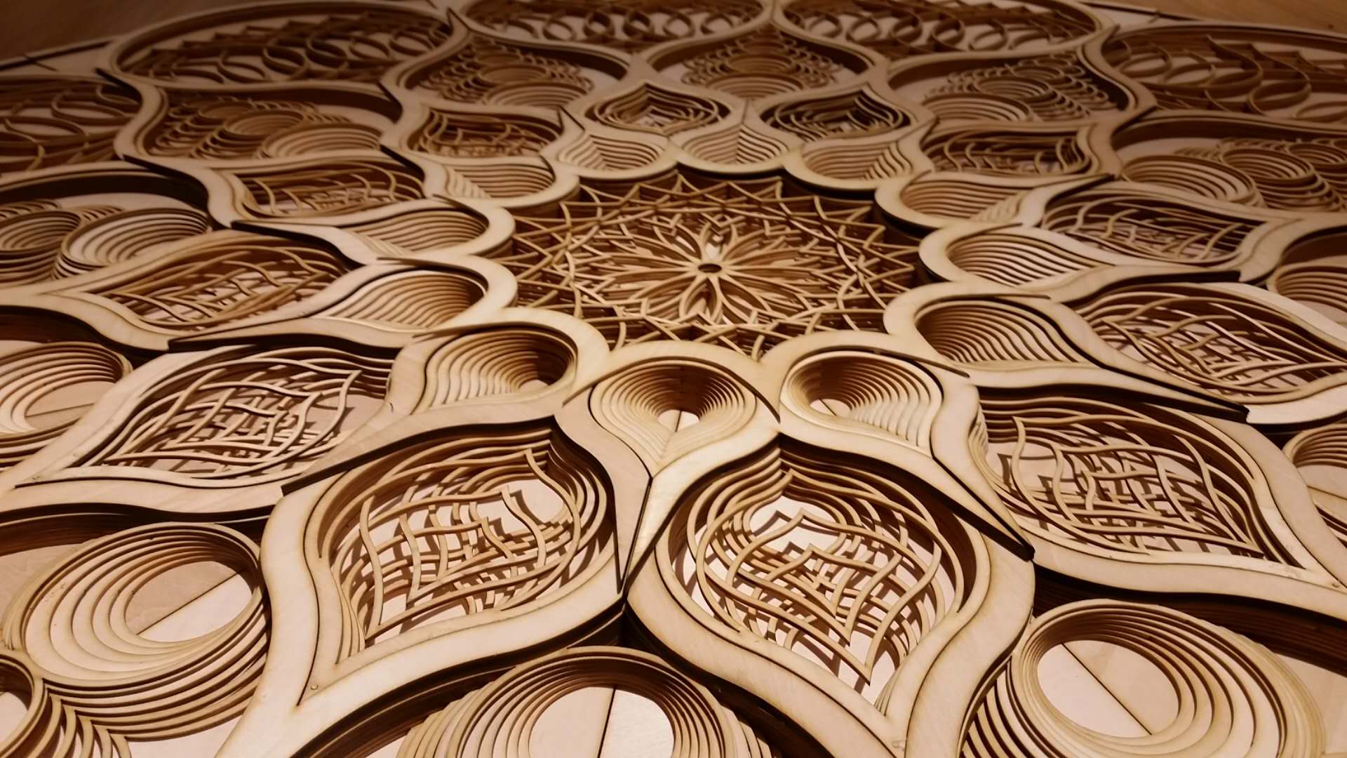 Close-up of an intricate wood laser-cut mandala pattern with layered petal shapes