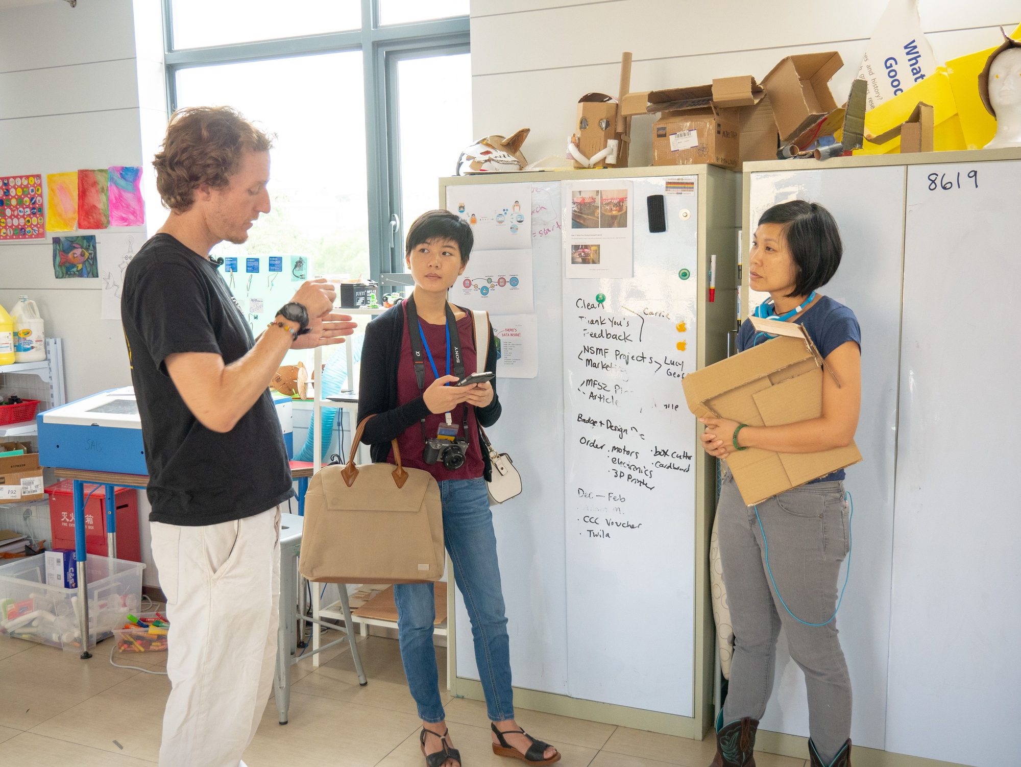 James, Bailey Hu, and Carrie Leung talking in the SteamHead workshop