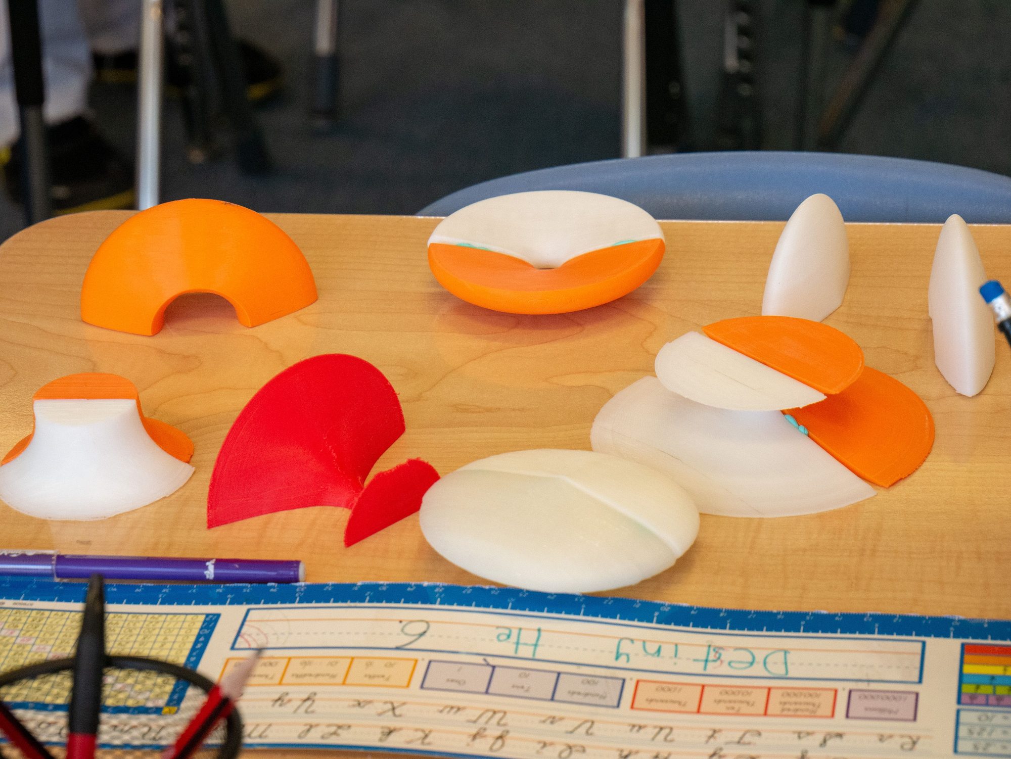 3D-printed cross-section shapes displayed on a desk
