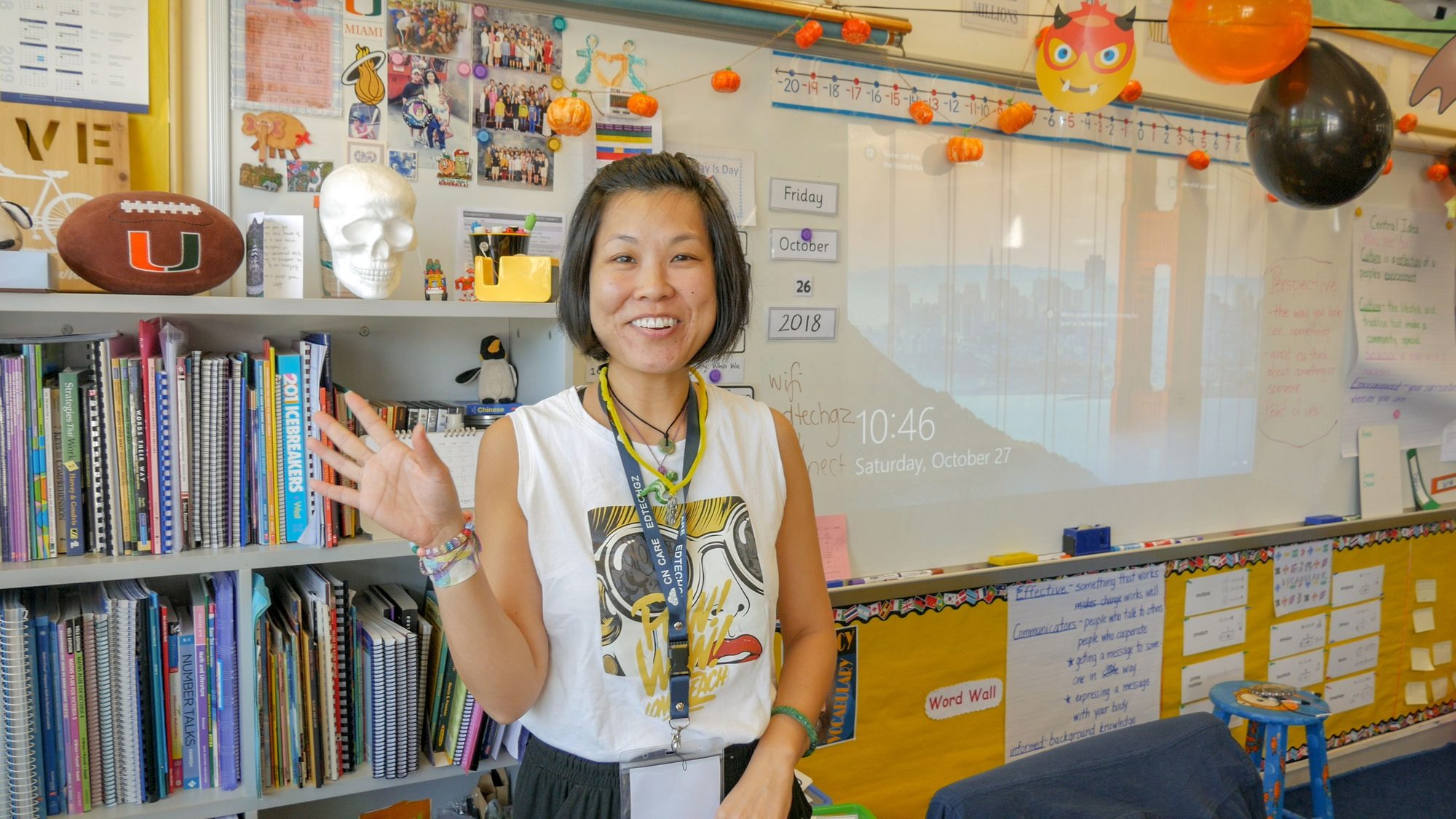Workshop presenter smiling while gesturing in a classroom