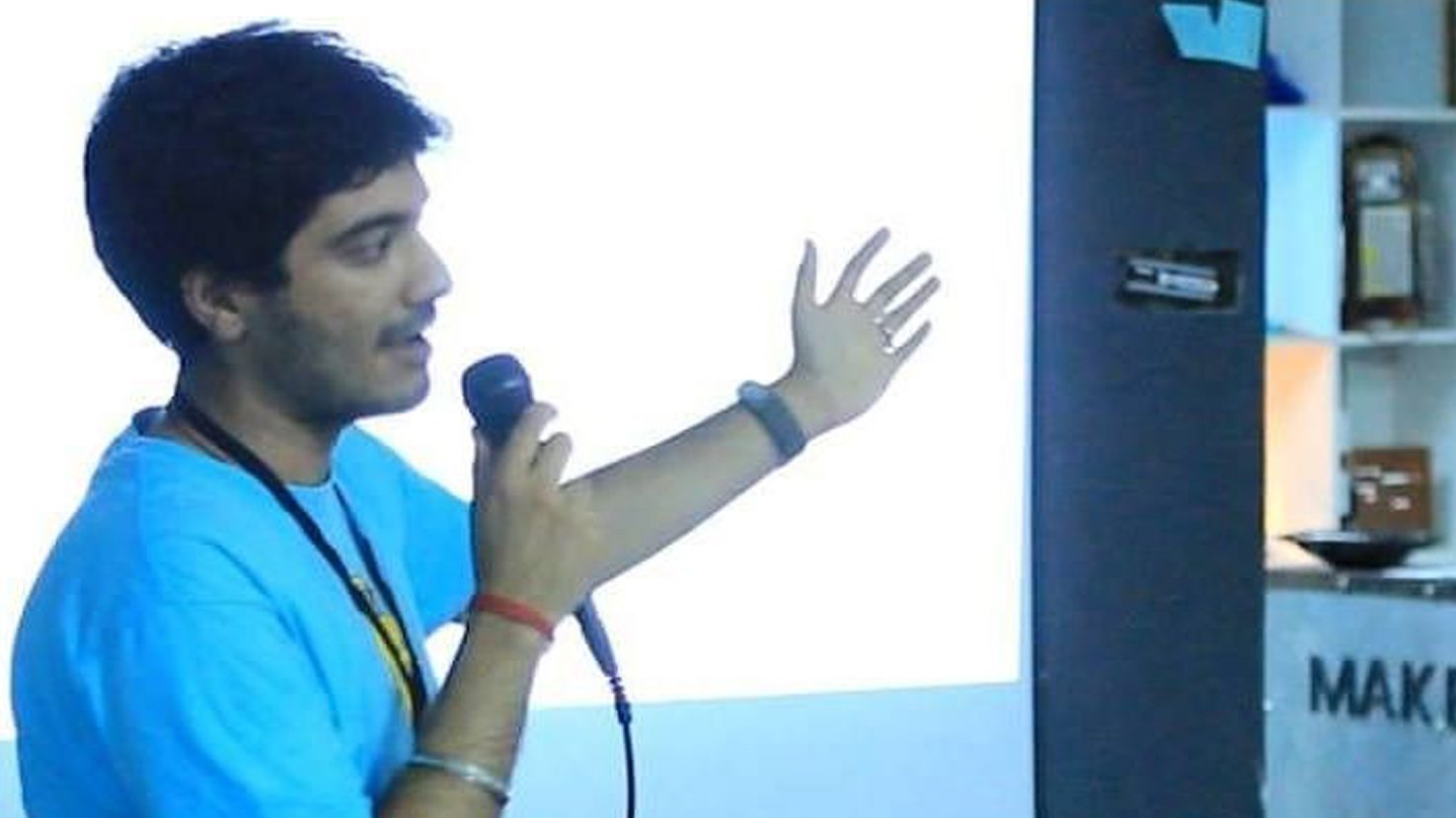 Pushp speaking at a presentation event