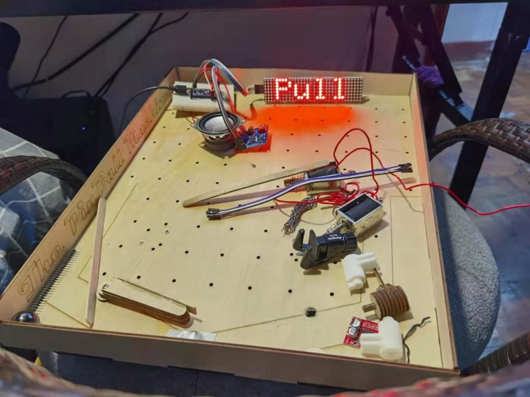 Handmade pinball machine board with wiring and an LED display reading 'Full'