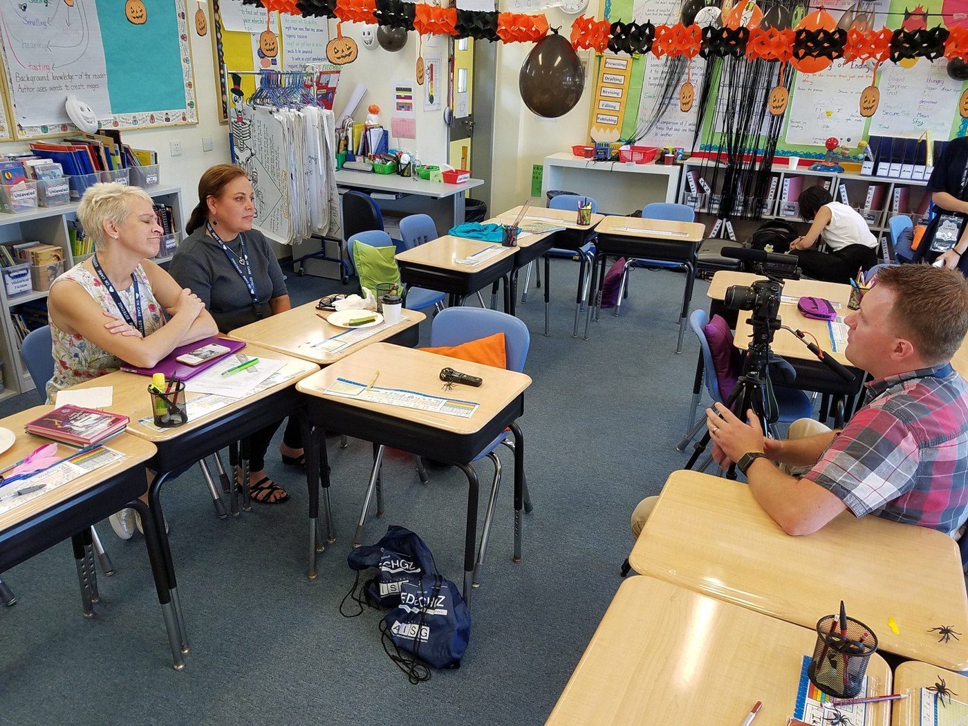 Teachers sharing classroom experiences during a filmed interview