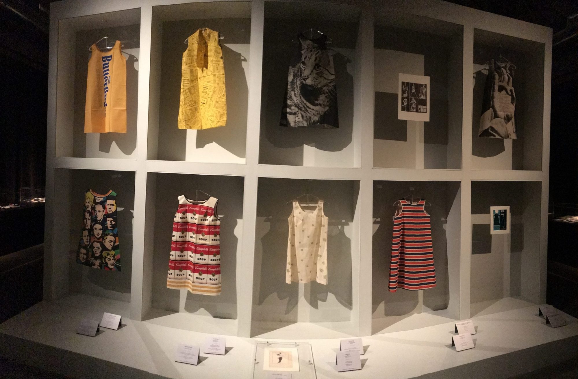 Paper dresses displayed in a textile museum exhibit case