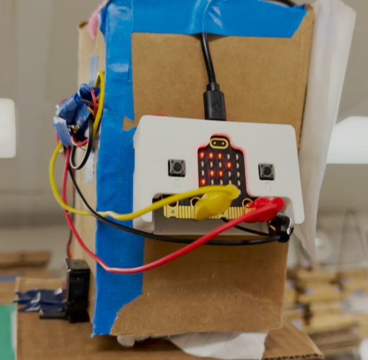 Cardboard snow box wired to a micro:bit and servo