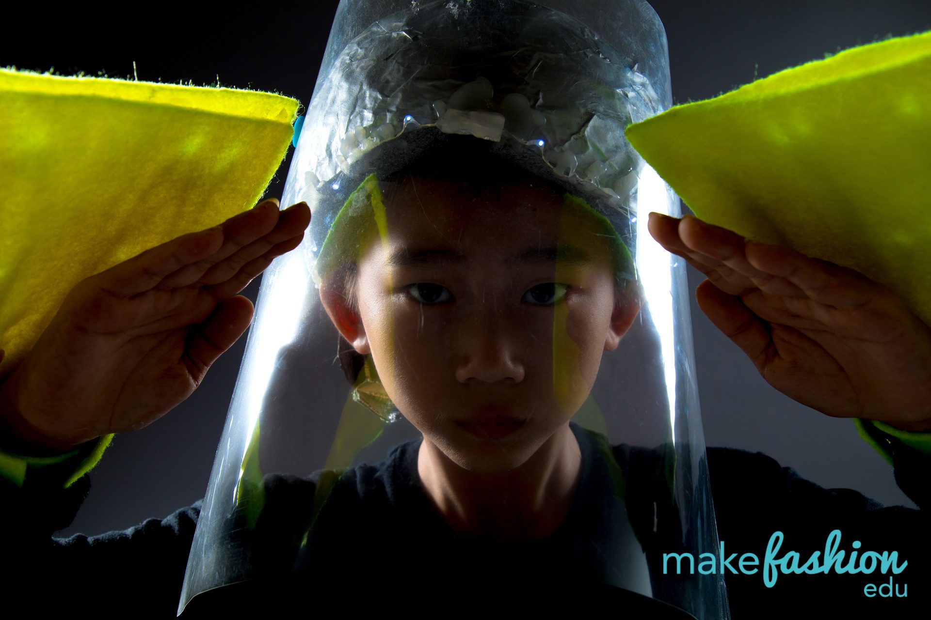 Clear illuminated headpiece framed by two yellow felt wing panels