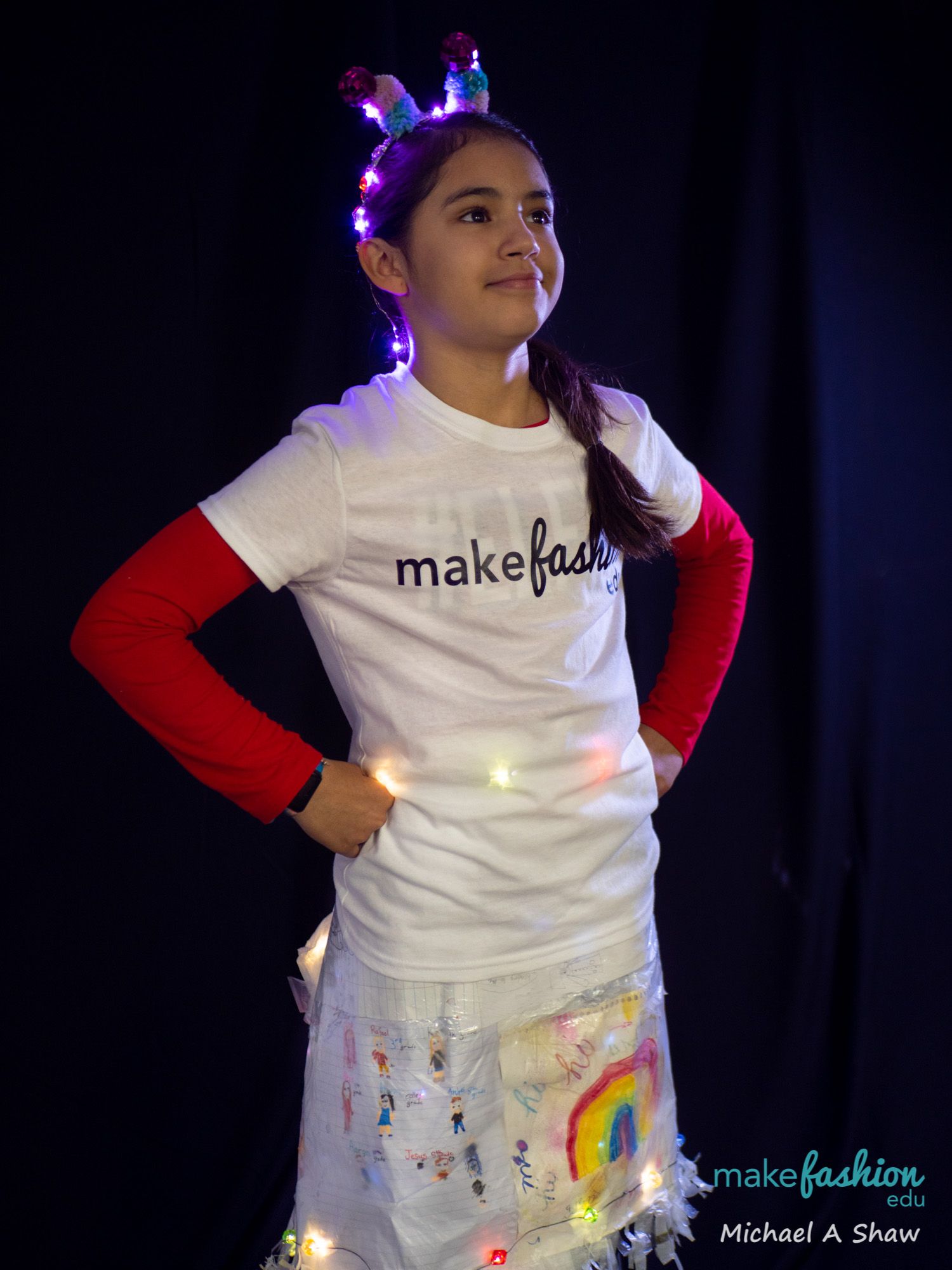 Student with light-up antennae headband and illustrated LED costume