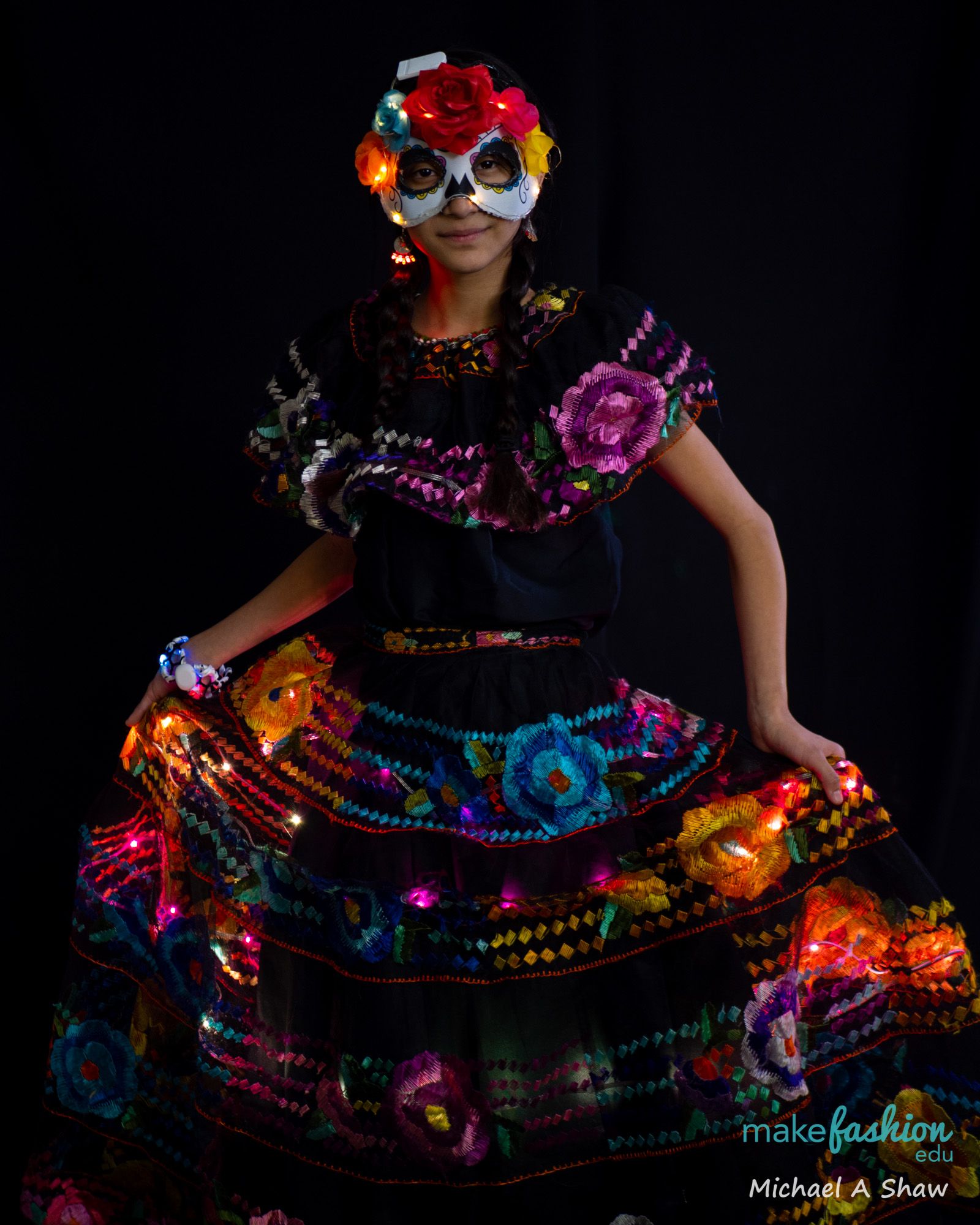 Student model showing off a light-up headband with pom-pom antennae