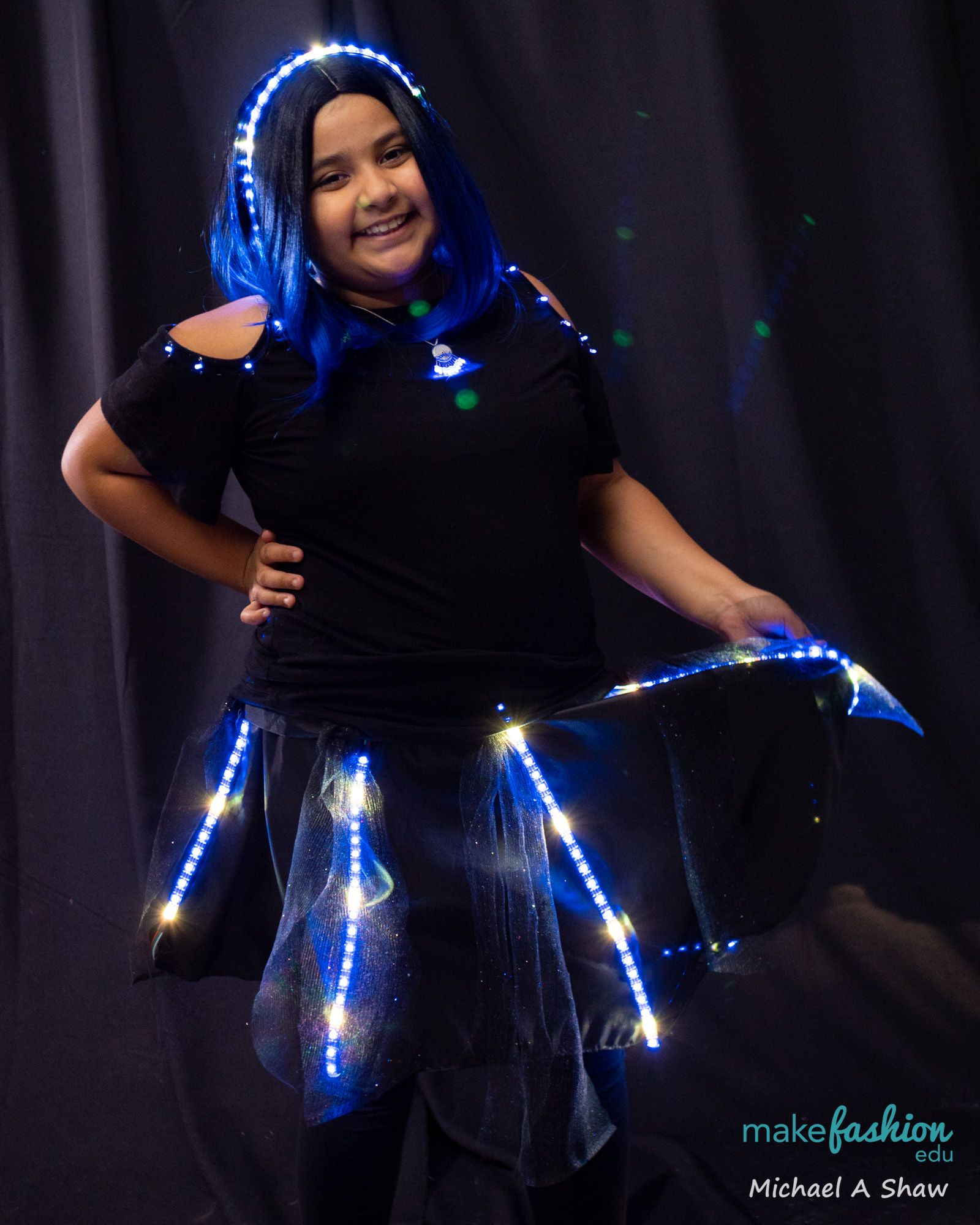 Student model in blue sheer skirt with blue and white LED lights