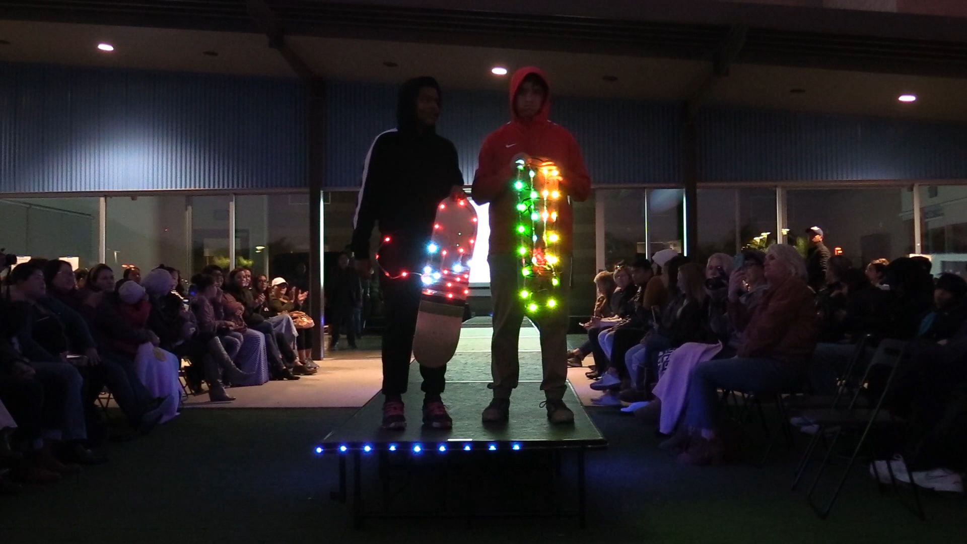 Two students on runway with multicolor LED accents and light strips