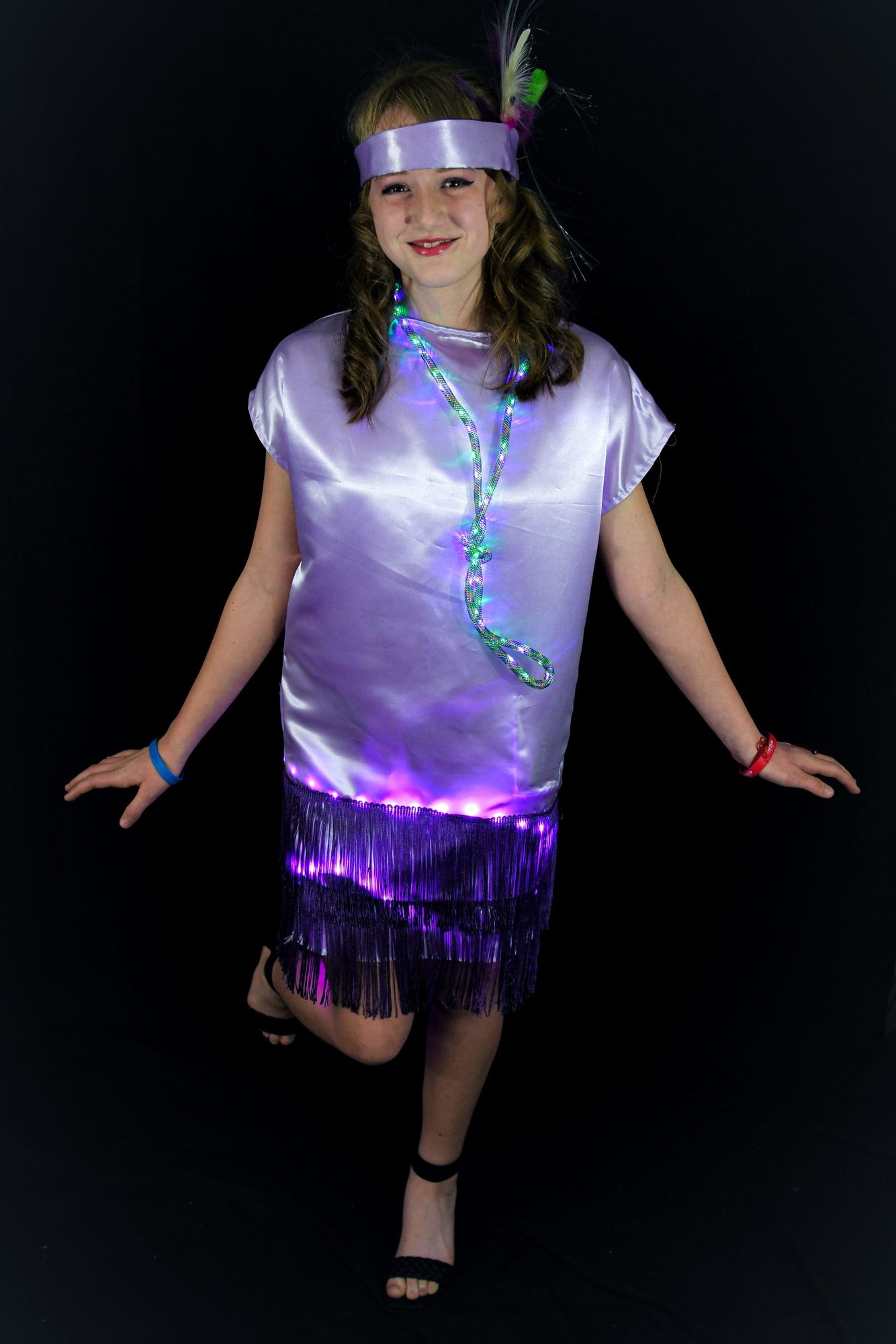 Student in lavender flapper dress with glowing LED hem and light-up rope necklace